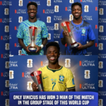 Vinicius Jr. smiling while proudly holding his three separate red and silver FIFA World Cup Man of the Match awards